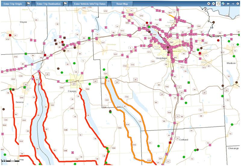 Screenshot from the NYSDOT Oversize/Overweight Tool showing a map of the area surrounding Syracuse, NY. Some roadways are color-coded red (restricted for large trucks) or orange (denotes construction or maintenance activity).
