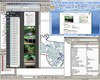 Screenshot from the New Haven Bridge Management Tool which shows a number of windows open that display maps, photographs, data tables, menus, etc.