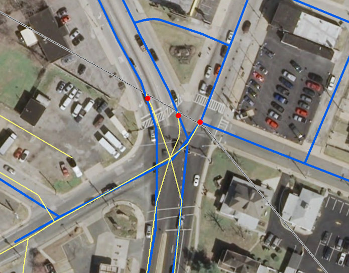 aerial photo of an intersection marked with blue and yellow lines and three red circles (smap-to points)
