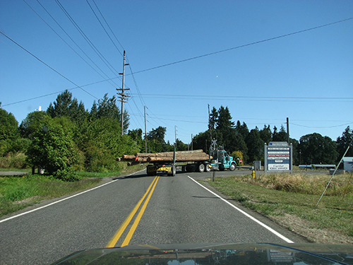 photo of a pole truck taking a right turn, which highlights the large overhang in the rear